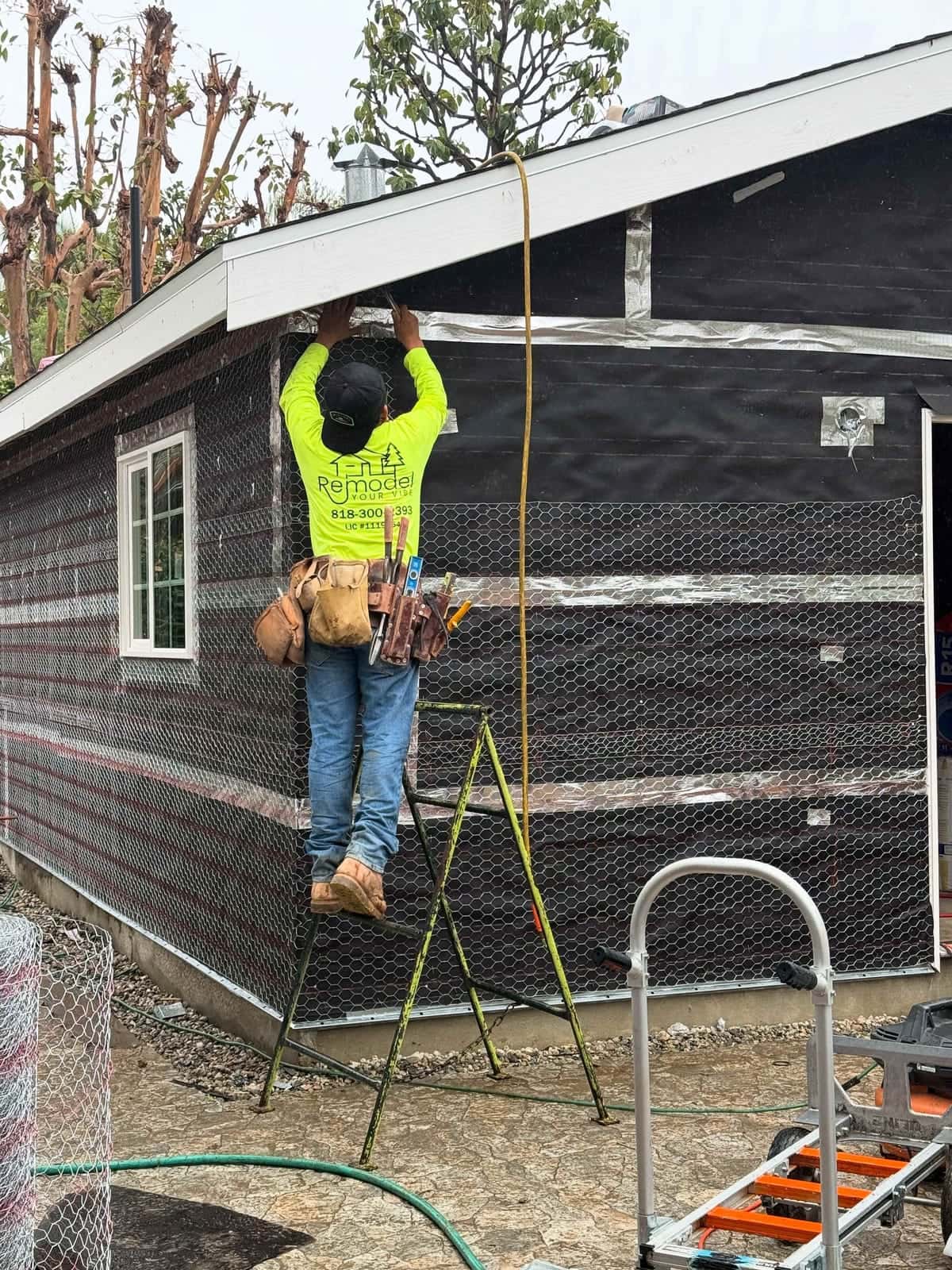 Wrapping an exterior wall with paper and lath before stucco