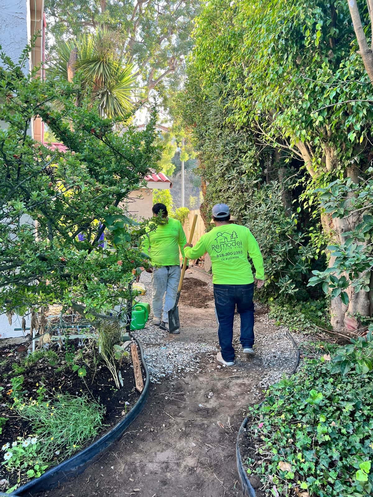 Crew working along a garden path on a landscaping job