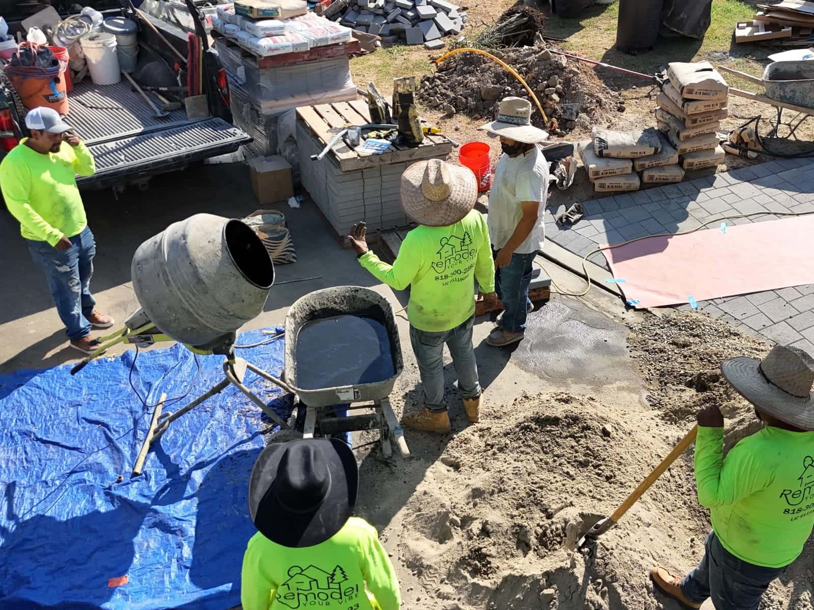 Crew mixing and staging materials for a paver install