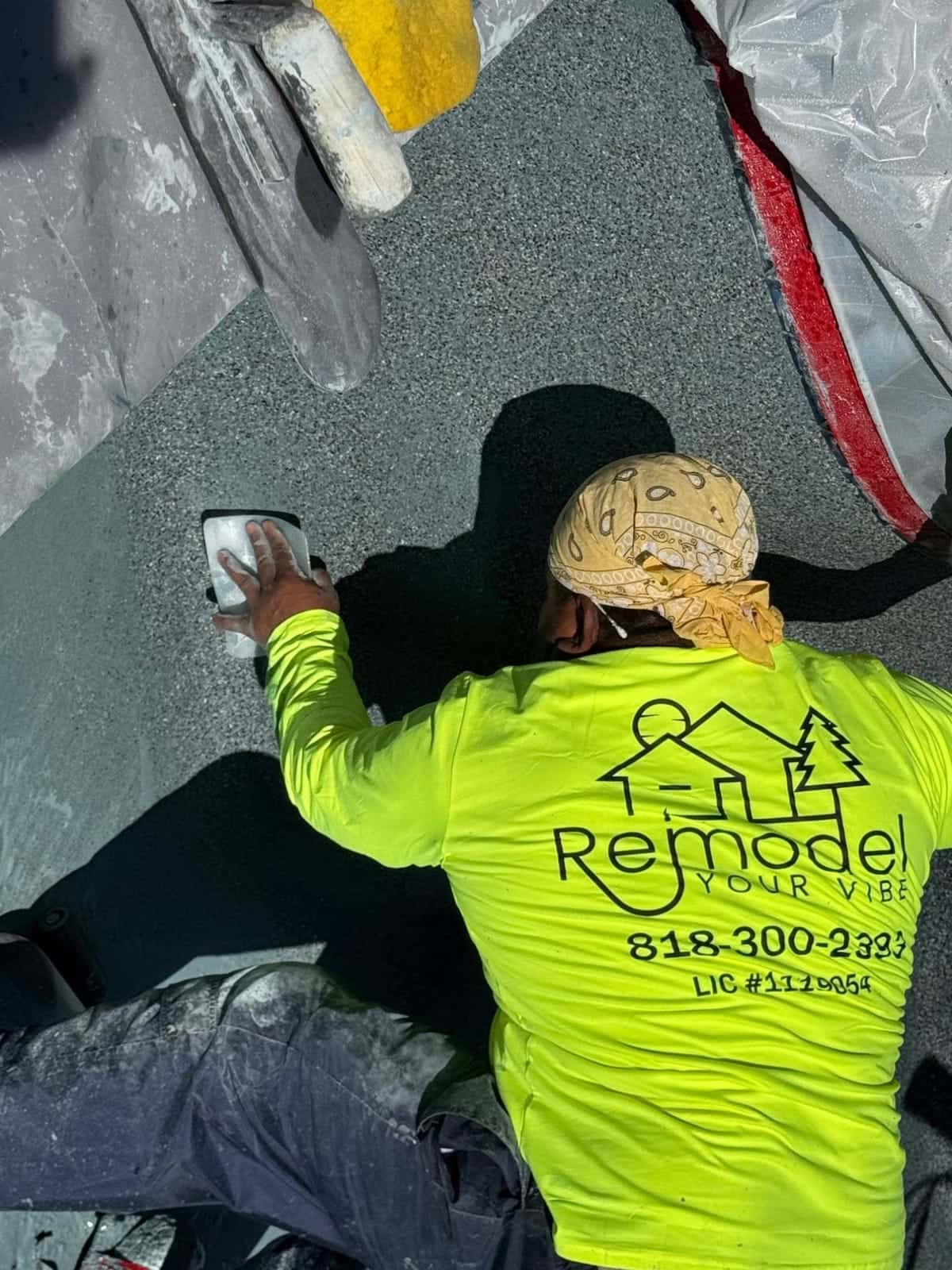 Crew member hand finishing a pool floor