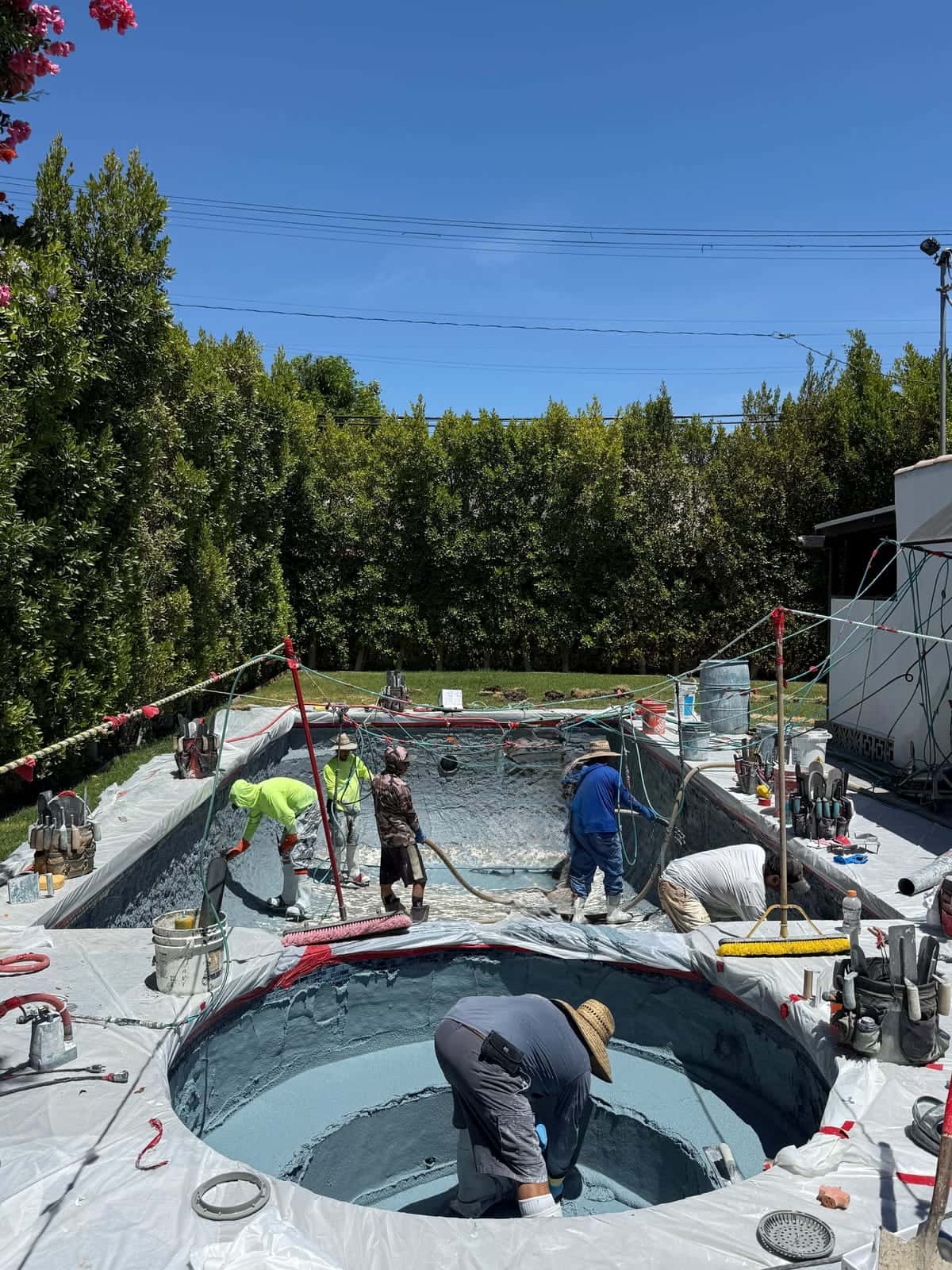 Crew working in a pool and spa during a remodel