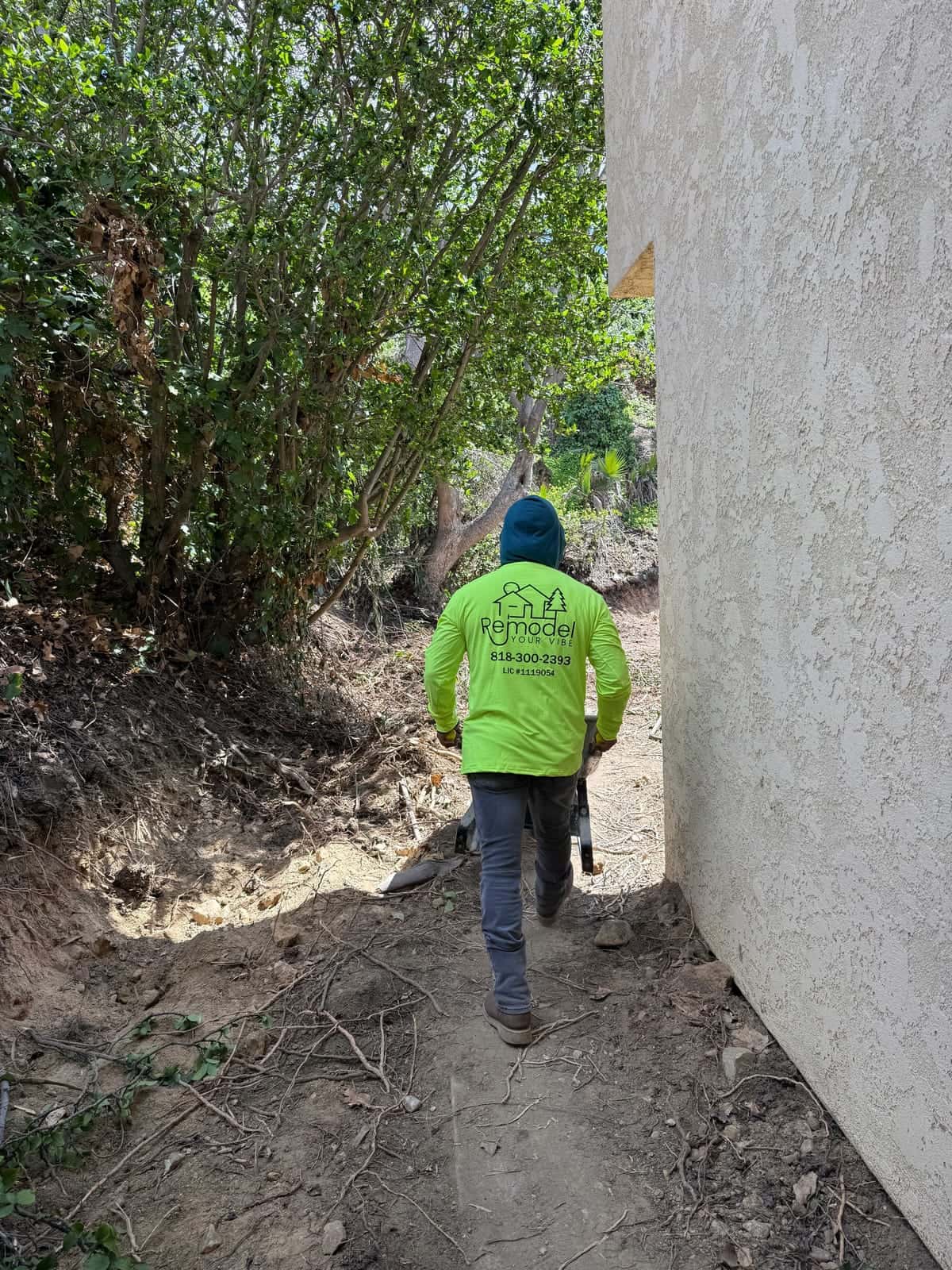 Crew member heading into a side yard for site prep